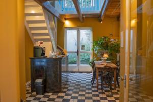 a dining room with a table and a window at The Guesthouse in Gouda