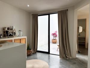 a kitchen with a sliding glass door with a plant at Casa 821 Guest House in Oaxaca City