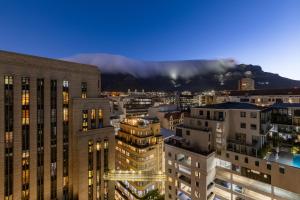 a view of a city with a mountain in the background at #1202 Cartwright - Bold & Stylish in Cape Town