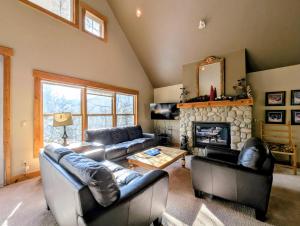 a living room with couches and a fireplace at Cabin in the Pines 4 by SummitCove Lodging in Colorado in Keystone +31 photos