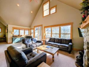 a living room with two couches and a table at Cabin in the Pines 4 by SummitCove Lodging in Colorado in Keystone