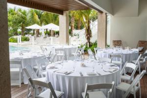 a table set up for a wedding with white tables and chairs at Fort Lauderdale Marriott Pompano Beach Resort in Pompano Beach
