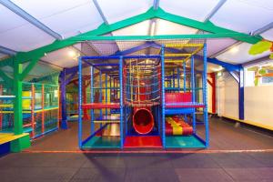 a playground with a slide in a play structure at Sallandse Stee - Stacaravan 5pers in Nijverdal