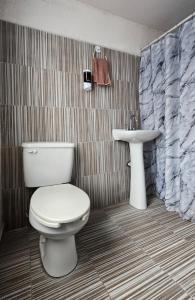 a bathroom with a toilet and a sink at Casa del Parque en Toluca in Toluca +40 photos
