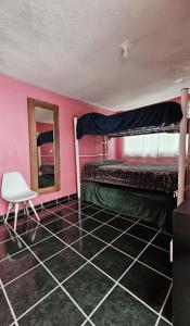 a bedroom with two bunk beds and a mirror at Casa del Parque en Toluca in Toluca