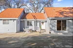 a small white house with an orange roof at Spacious 6 BR • Patio + Deck • Sleeps 13 in Sacramento