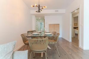 a dining room with a glass table and chairs at RentitSpain - Playa Granada - Apartamentos TRM Aguacate Relax entre Mar, Golf y Montaña in Motril