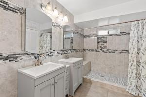 a bathroom with two sinks and a shower at Spacious 6 BR • Patio + Deck • Sleeps 13 in Sacramento +35 photos