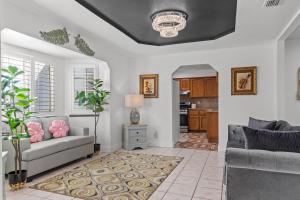 a living room with a couch and a table at Spacious 6 BR • Patio + Deck • Sleeps 13 in Sacramento