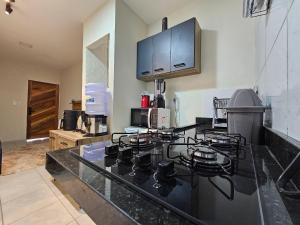a kitchen with a stove top oven in a kitchen at Maria Bonita Apartment | Cozy, 10 minutes from the city center in Caruaru