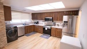 a kitchen with wooden cabinets and stainless steel appliances at 3 cozy bedrooms 2 bathrooms in Winnipeg
