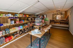 a store aisle with shelves of food and drinks at Sallandse Stee - Stacaravan 5pers in Nijverdal