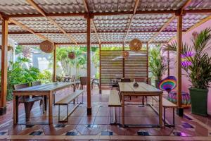 a patio with wooden tables and chairs and plants at Mucura Hotel & Spa in Cartagena de Indias