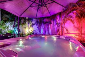 a hot tub in a room with palm trees at Mucura Hotel & Spa in Cartagena de Indias