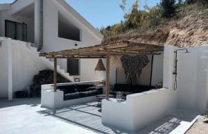 a patio with a couch under a wooden pergola at Casa Laguna in Iznájar