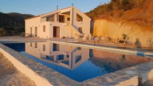 a house with a swimming pool in front of it at Casa Laguna in Iznájar