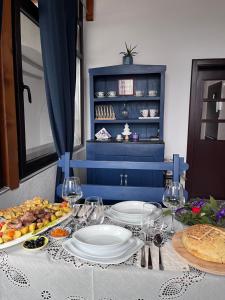 a table with plates of food and wine glasses at Lavender farm Zarić in Porosanica