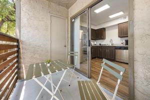a kitchen with a table and chairs on a balcony at Emerald Loft - Pool, Gym & Free Parking! in Dallas +6 photos