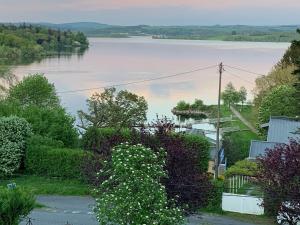 a view of a lake from a house at Confortable appartement vue lac de Pareloup in Arvieu