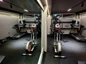 a gym with several tread machines in a room at Galaxy Hotel in Ierapetra