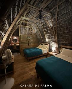 a bedroom with two beds in a bamboo house at Casa Lorette in Martínez +22 photos
