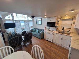 a kitchen and living room with a couch and a table at Oceanfront Cabin 4 with Jacuzzi Pet Friendly in Smith River