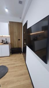 a kitchen with white cabinets and a counter top at Anpol 1 idealny dla jednej osoby in Inowrocław +9 photos