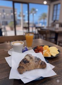 a table with a plate of food on a table at Golden house in Cefalù