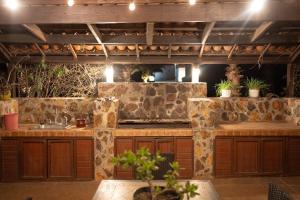 a kitchen with a stone wall and a sink at Tierra Mia Hacienda Ruta del Vino in Valle de Guadalupe
