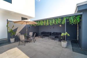 a patio with a table and chairs and an umbrella at One90 Apartment in Lagos