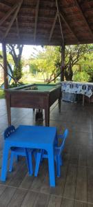 a pool table with a bench and a ping pong table at Pousada Mosselini in São Gabriel