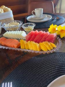 a tray of different colored fruits on a table at LIMMAT Chalés- Presidente Juscelino, MA in Morros