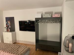 a room with a bed and a shelf with glasses at WOOD hOUSE in Vrbovsko