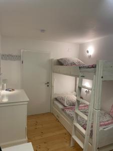 a room with two bunk beds and a desk at WOOD hOUSE in Vrbovsko