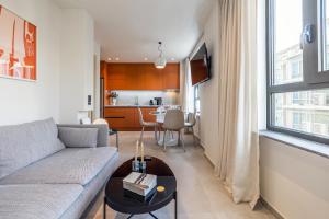 a living room with a couch and a table at Raise Porta Nuova in Heraklio