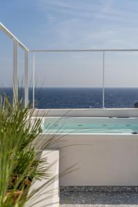 a view of the ocean from the balcony of a house at Lindos 4 me Villa in Lindos