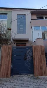 a blue garage door in front of a house at Zenith Apartment in Bitola
