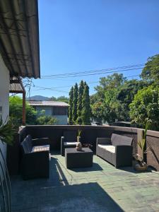 a patio with couches and tables on a roof at Casa Bri in Antiguo Cuscatlán