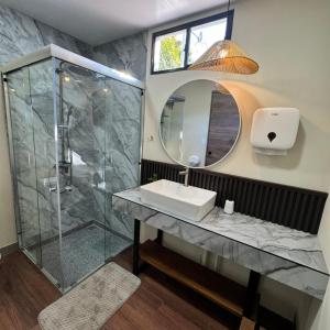 a bathroom with a sink and a shower at Casa Bri in Antiguo Cuscatlán +32 photos