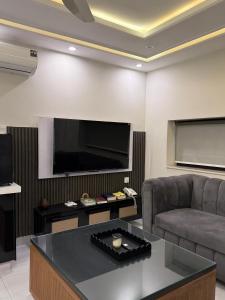 a living room with a couch and a flat screen tv at Serenity Residence Room Studio 1BHK in Rachiāl +4 photos