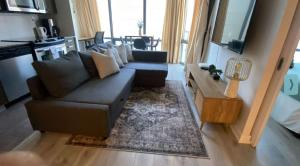 a living room with a couch and a table at Functional Condo Sleep 6 in Port Hope