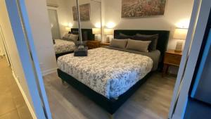 a bedroom with a bed with a lamp on it at Functional Condo Sleep 6 in Port Hope +1 photo