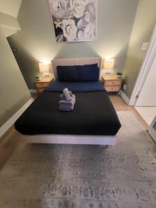 a bedroom with a large bed with two night stands at Small Apartment for 2 in St. Catharines +3 photos