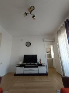 a living room with a stove and a white wall at Zenith Apartment in Bitola