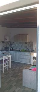 a kitchen with a table and a counter top at Casa Sol Naciente in Villa Santa Cruz del Lago
