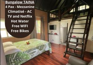 a bedroom with a bunk bed and a ladder at Pension Hibiscus Taha'a in Vaitoare +63 photos
