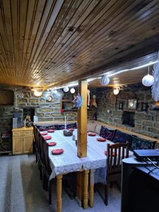 a dining room with a long table and chairs at Дядо Цоньовата къща самостоятелен имот с басейн in Sevlievo