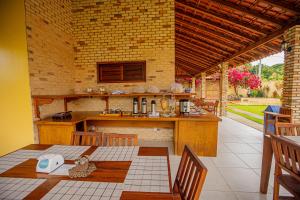 an outdoor kitchen with a table and a counter at Pousada Sítio Machado in Viçosa do Ceará