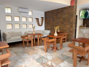 a living room with wooden tables and a couch at Quinta Nina Playa del Carmen - Solo Adultos in Playa del Carmen