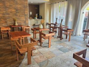 a dining room with wooden tables and benches at Quinta Nina Playa del Carmen - Solo Adultos in Playa del Carmen